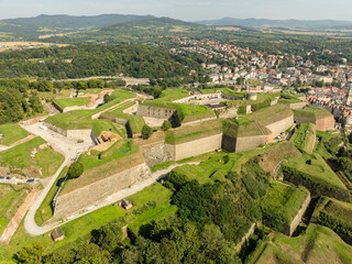 Klodzko Fortress (German: Festung Glatz) – a preserved fortress in Klodzko, a defense system from the 17th and 18th centuries in Poland. Aerial drone view of Klodzko Fortress and town Klodzko..