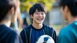 © siripimon2525 - Joyful Japanese Student with Soccer Ball in Candid Portrait