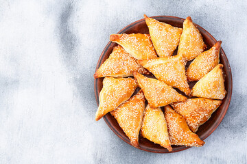 Homemade triangle puff pastry with meat on rustic background . Samosa