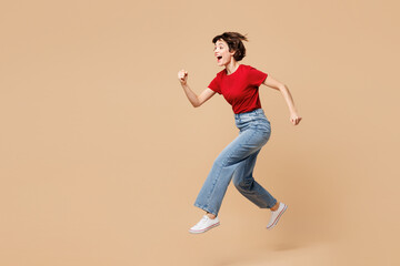 full body side view excited young smiling happy woman she wear red t-shirt casual clothes jump high 