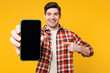 © ViDi Studio - Young man he wears red checkered shirt casual clothes hold in hand use point finger on mobile cell phone with blank screen workspace area isolated on plain yellow orange background. Lifestyle concept.