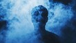 © thenort - A silhouette of a man standing in a haze of purple smoke.