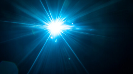 Poster - Bright blue light with radiant beams illuminating a dark environment at night