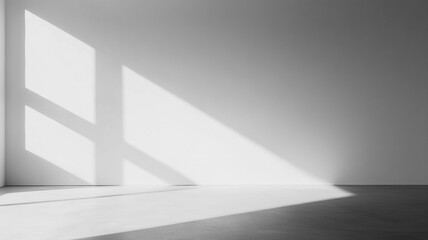 Poster - Bright sunlight casts geometric shadows on a minimalistic white interior space in the afternoon