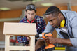 © auremar - two carpenters working at locationrepairing furniture