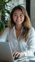 Poster - A woman is sitting at a desk with a laptop in front of her