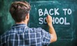 © Pumapala - Student Writing Back to School on a Chalkboard