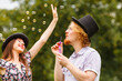 © Voyagerix - Couple blowing soap bubbles, having fun