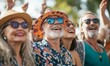 © Murda - Smiling people wearing sunglasses and hats at a festival.