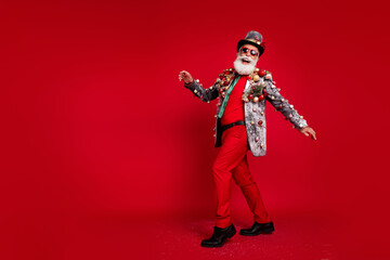 Canvas Print - Full body photo of santa claus funny man have fun good mood dressed christmas tree balls costume sunglasses isolated red color background