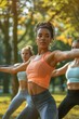 © vefimov - Women participating in outdoor yoga class on a sunny day