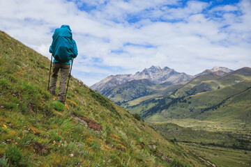 Poster - Woman backpacker hiking on high altitude mountains top