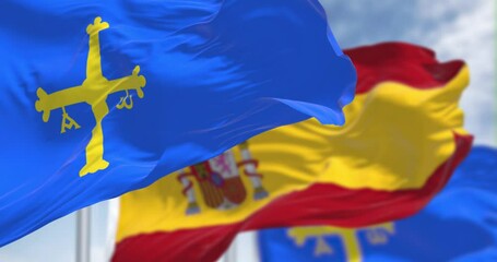 Wall Mural - The Asturias flags waving with Spanish flag on a clear day