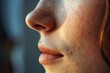 © juliars - Close up of a young woman's face with freckles, highlighting her natural beauty