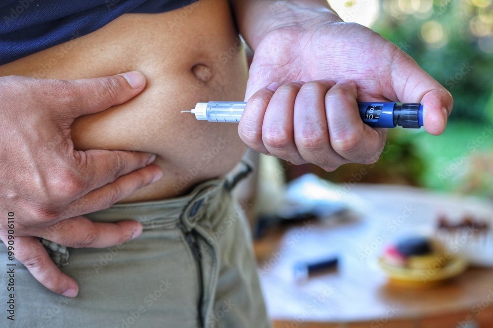 Close up of man hands is making injection with insulin penfill or ...