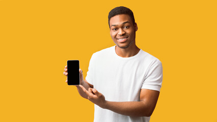 Poster - Useful App Or Website. Black man pointing at blank cell phone screen for advertising text, empty space, mock up