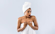 © Prostock-studio - Amazing spa deal. Black woman wrapped in towels expressing shocking emotions, grey background