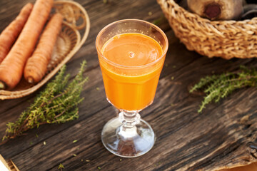 A glass of fresh carrot juice on a table