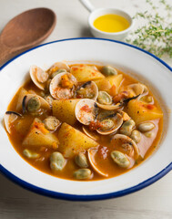 Fish stew with clams, potatoes and green beans. Traditional Spanish recipe.