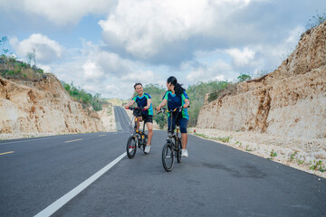 couple biker enjoying biking together in the mountain road, healthy lifestyle