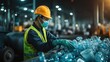 © B 7 YOU - Worker in a safety vest and mask sorts through a bin of plastic bottles.