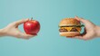 © BaiBoon - Two hands reaching for an apple and a hamburger, against a blue background, representing the concept of health versus fast food. The close-up image shows a hand holding either a piece of fruit