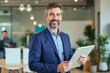 © f_bossa - A portrait headshot photo of a friendly professional CEO executive business worker