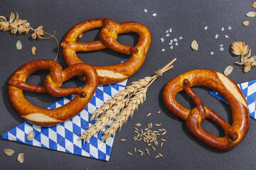 Wall Mural - Traditional Oktoberfest Pretzels. German festival food concept. Trendy hard light, dark shadow