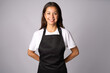 © Gecko Studio - Friendly waitress, female barista in black apron. Young woman wearing black apron and white shirt standing on a white background with copy space