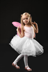 Wall Mural - Cute girl dressed like fairy on black background. Halloween costume