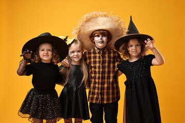 Poster - Cute children wearing Halloween costumes on orange background