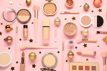 Wall Mural - Different makeup brushes, decorative cosmetics and Christmas decor on pink background, flat lay