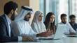© Andres Mejia - Arab businessman leading a meeting in a diverse office