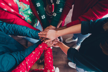 Wall Mural - Cropped photo of cheerful young people colleagues hold hands circle teamwork cozy christmas party decor spacious office indoors