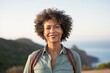© Markus Schröder - Portrait of a tender afro-american woman in her 50s sporting a breathable hiking shirt over serene seaside background