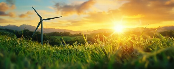 Wind turbine on a field during a vibrant sunset with gentle grass.