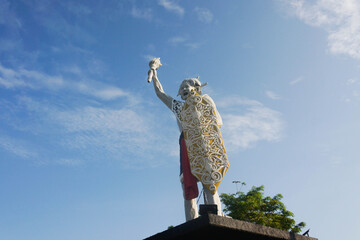 a welcome statue in the form of a Dayak man from Balikpapan city with isolated blue sky