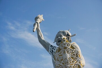 a welcome statue in the form of a Dayak man from Balikpapan city with isolated blue sky