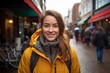 © Markus Schröder - Portrait of a satisfied woman in her 20s wearing a windproof softshell on vibrant market street background