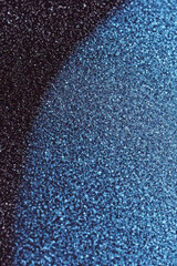 Poster - Grainy gradient background, Close-up of shimmering blue glitter on a dark surface, creating a captivating play of light and color, perfect for artistic or festive designs.