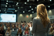 © Chebix - A woman is standing in front of a crowd and speaking into a microphone