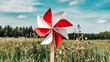 © Diclonius - Colorful Pinwheel Spins in the Breeze on a Sunny Day Amidst Tall Grass and Trees