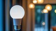© arthit - Close-up of a modern LED bulb against a blurred background, leaving plenty of room on the right for copy.