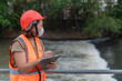 © reewungjunerr - Asian Female engineering working . at sewage treatment plant,Marine biologist analysing water test results,World environment day concept