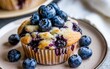 Blueberry muffin treat. Delicious blueberry muffin topped with fresh blueberries, perfect for a sweet snack or breakfast.