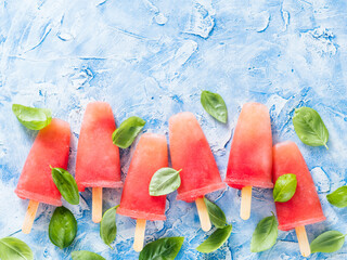 Wall Mural - Top view of watermelon and basil popsicles with copy space. Popsicles recipe idea.