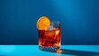 © Iqra - Popular cocktail negroni with gin and vermouth on blue background with shadow. Negroni cocktail on coloured background in trendy style. Contemporary concept with alcohol beverage. Bartender cocktail