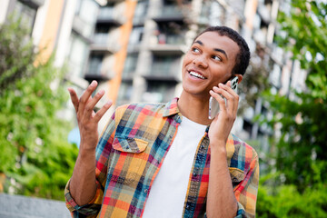 Canvas Print - Portrait of nice young man communicate phone wear shirt buildings city center outdoors