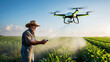 © JuliaM - farmer dressed in overalls and a wide-brimmed hat skillfully pilots a drone over an expansive green crop field