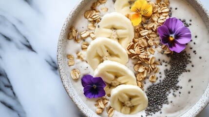 Poster - a thick, creamy smoothie bowl topped with banana slices, granola, chia seeds, and edible flowers. 